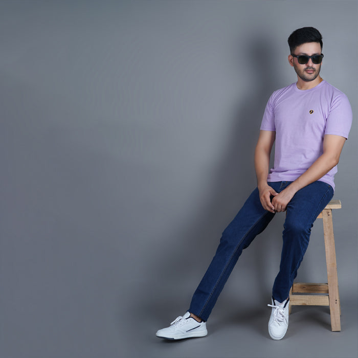 sitting on a stool men wearing pure cotton half sleeve round neck t shirt lilac soft purple color breathable everyday wear premium comfort