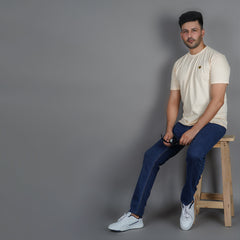 men sitting on a stool wearing pure cotton half sleeve round neck t shirt california peach breathable everyday wear premium comfort