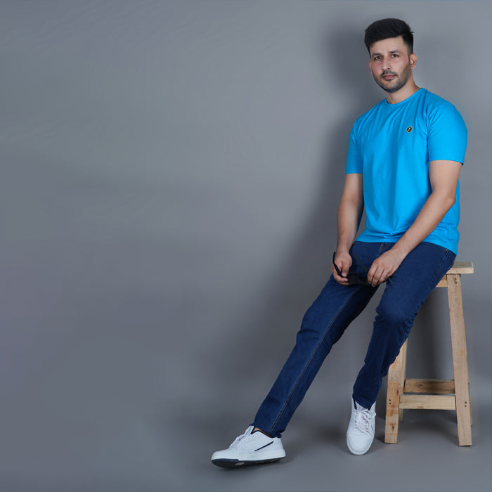 men wearing pure cotton lycra half sleeve round neck t shirt aqua blue breathable everyday wear premium comfort sitting and paired with dark blue premium EPG jeans