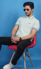men wearing cotton lycra half sleeve polo t shirt pistachio soft green color breathable everyday wear premium comfort paired with black color EPG jeans